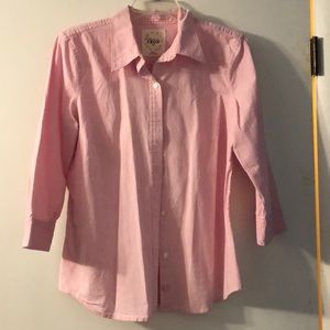 Pink button down collared shirt.